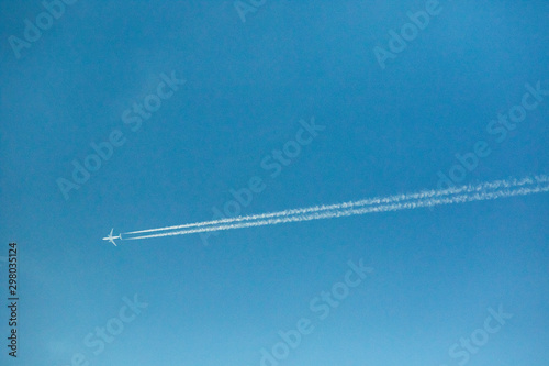 jet plane and contrail against clear blue sky
