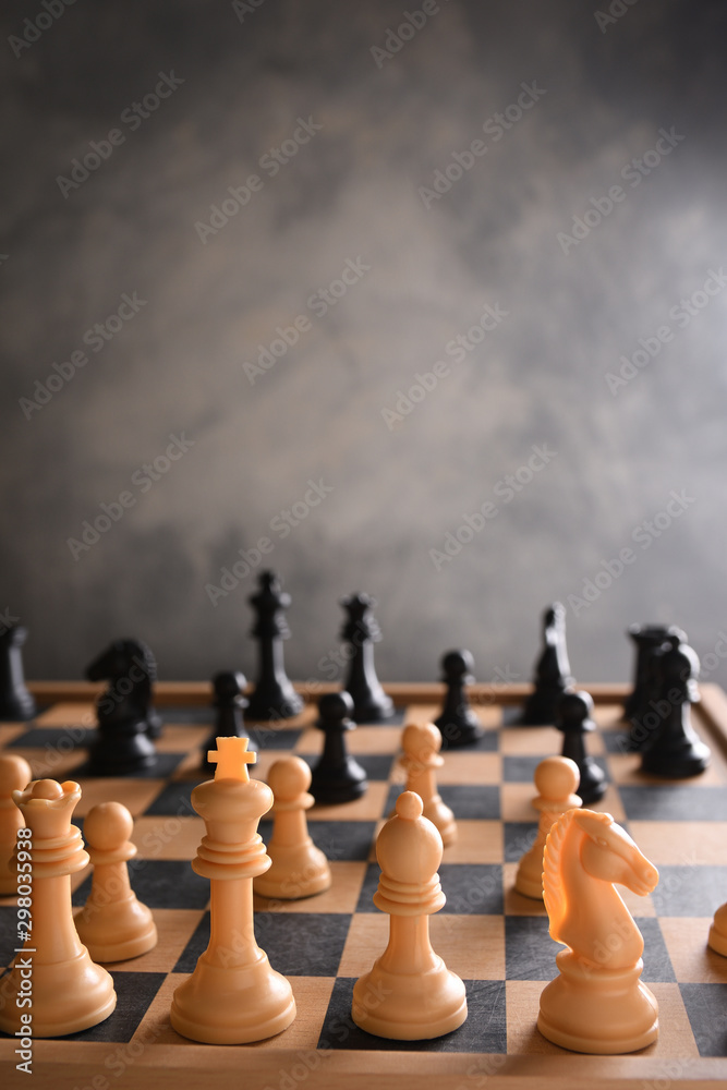Chess board with chess, black and white on a gray background