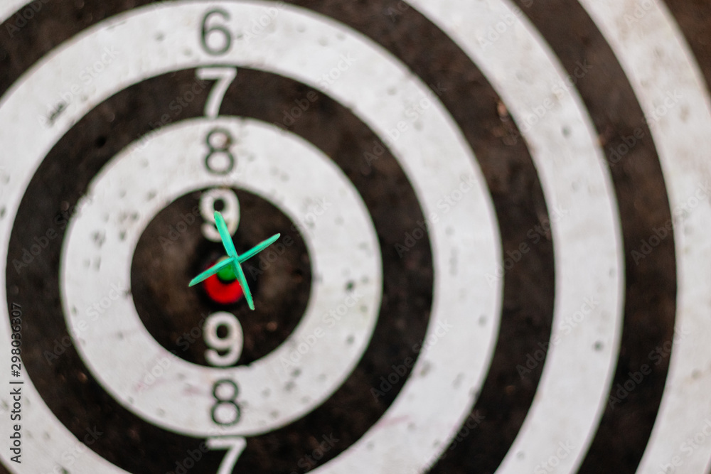 Green arrow in the center of the dart board Shows the concept of business goal setting. Green arrow in the center of the dart board Shows the concept of business goal setting.