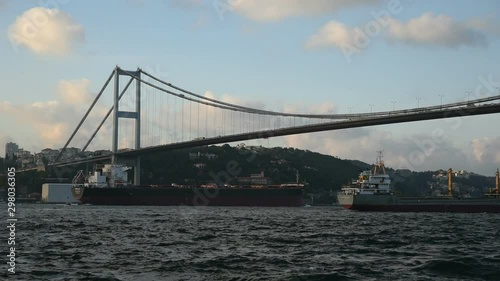 Two tanker ships are passing under The Bosphorus Bridge at Istanbul.
