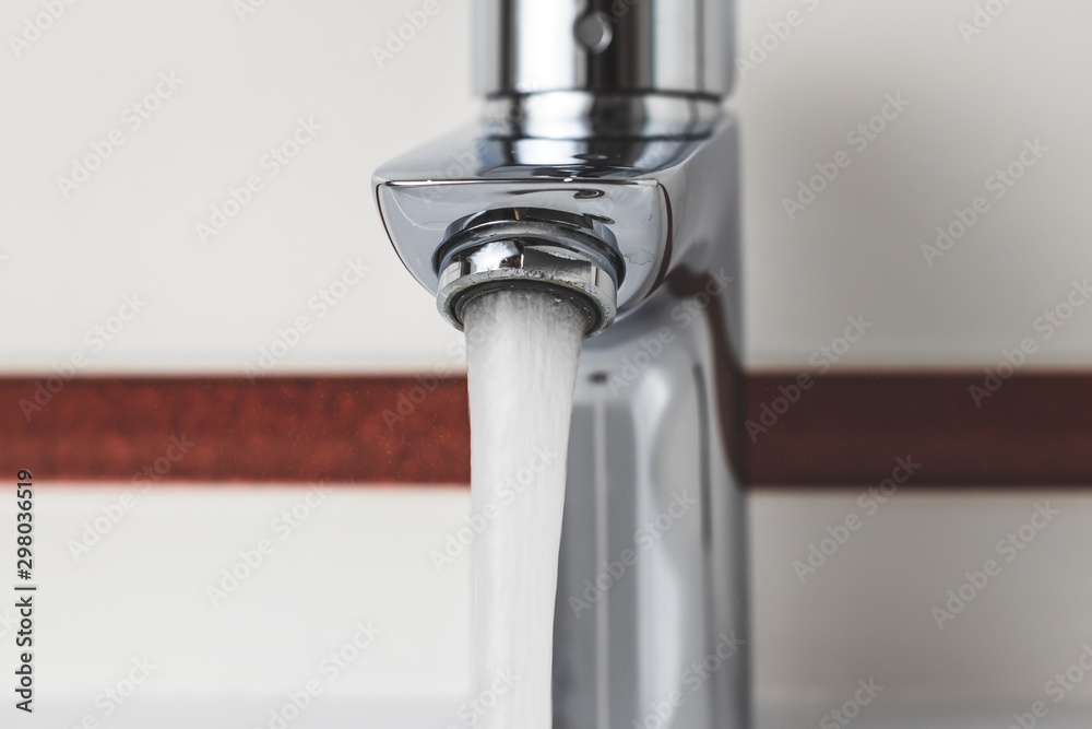 Water tap close-up. Water flow, stream. Water is pouring from the tap. Water tap close-up. Water flow, stream. Water is pouring from the tap.