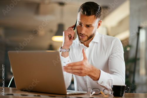 Businessman discussing work on phone