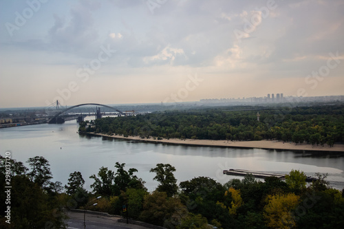 Tour of Kiev in the center of Europe. View of the Dnieper, Trukhanov island and a foot bridge. Park fountain and sunset on the horizon.. © Игорь Глущенко