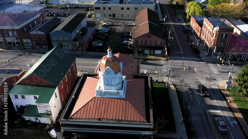 Aerial camera push in and pitch down onto the coupala dome of the Hampshire County Courthouse in Romney West Virginia in autumn. photo