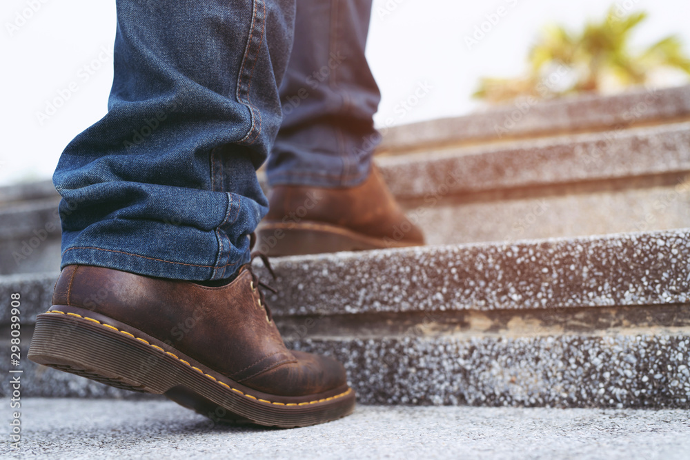 modern businessman working close-up legs walking up the stairs in modern city. in rush hour to work in office a hurry. During the first morning of work. stairway. soft focus. modern businessman working close-up legs walking up the stairs in modern city. in rush hour to work in office a hurry. During the first morning of work. stairway. soft focus.