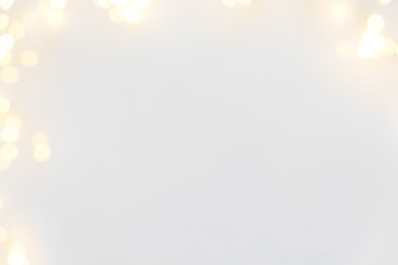 Defocused Christmas lights on white wooden background. Christmas and New Year holidays celebration concept