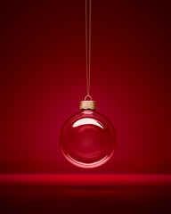Christmas glass bauble hanging in front of luxury dark red background. Transparent winter decoration.