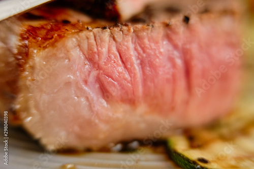 Macro photo with shallow depth of field of section of beef steak medium rare