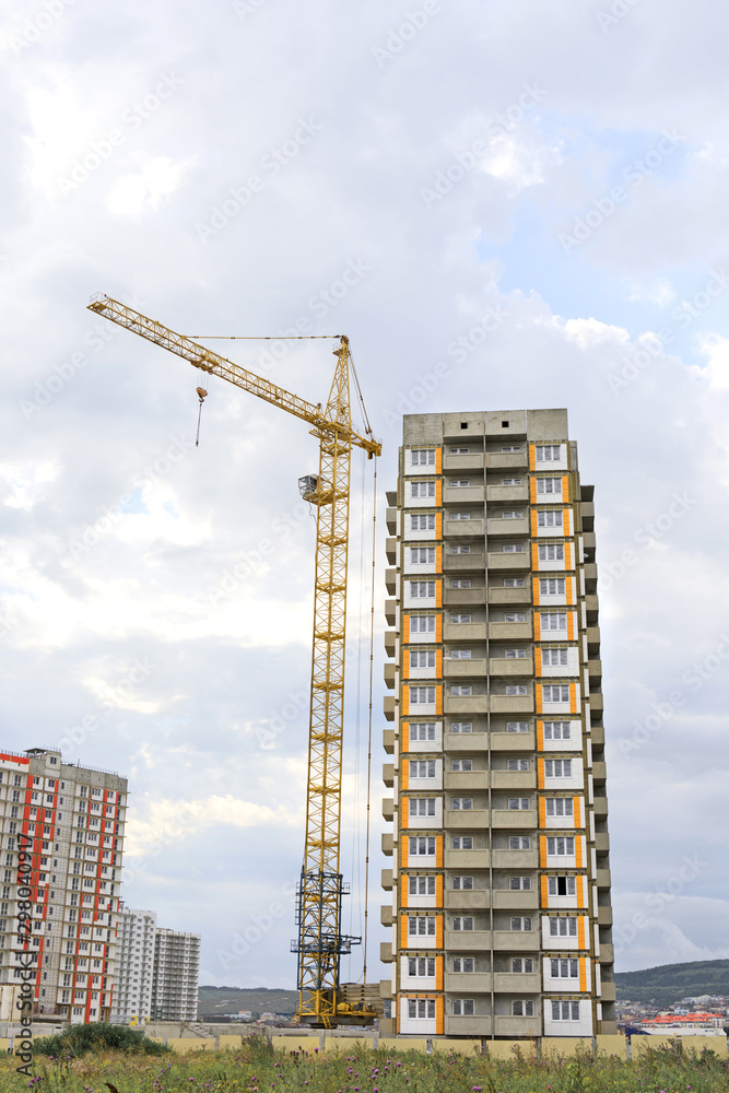 .high-rise building construction. Construction crane against the sky. House under construction .high-rise building construction. Construction crane against the sky. House under construction