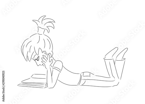 cute girl lying on her belly reading a book