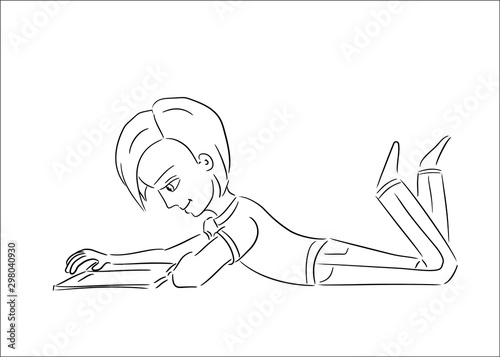 cute boy lying on his belly reading a book