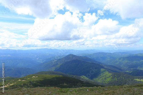 Blue and green wonderful Alps mountains with clouds in background. photo