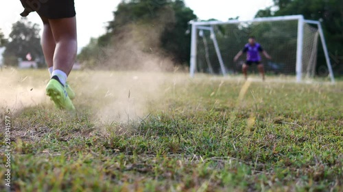 The Asian children are plying football in the glass field.	 photo