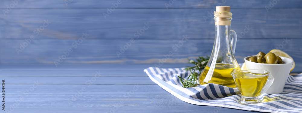 Tasty olive oil on wooden table with space for text - obrazy, fototapety, plakaty 