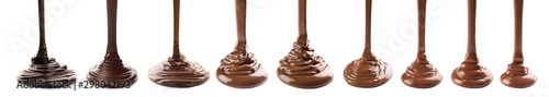 Fotografie Pouring melted chocolate on white background