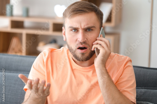 Confused young man talking ...