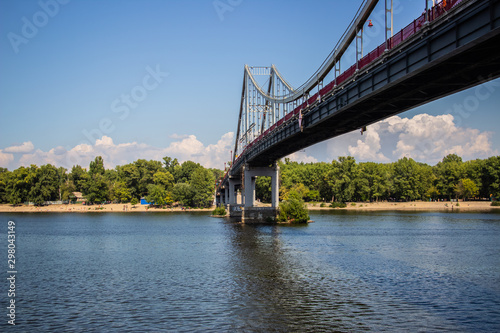 Tour of Kiev in the center of Europe. View of the Dnieper, Trukhanov island and a foot bridge. Park fountain and sunset on the horizon..