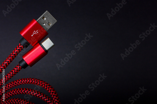 Red USB cable for smartphone isolated on white background. photo