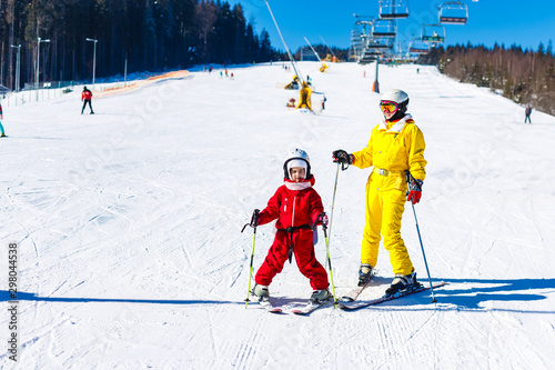 mother and daughter in bright winter ski suits