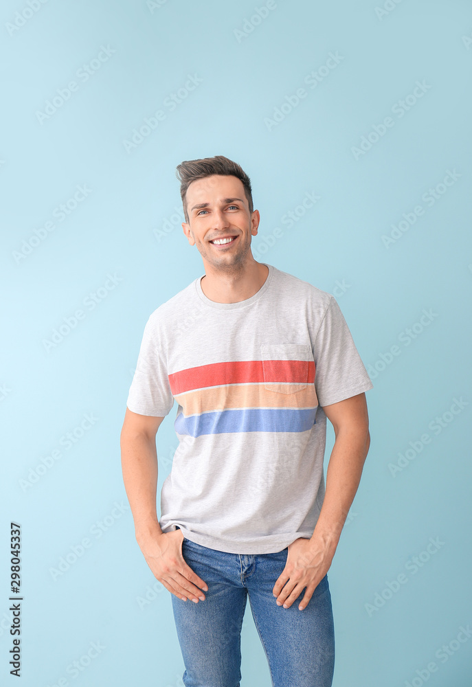 Fototapeta premium Portrait of stylish young man on color background