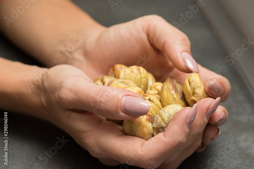 Hands holding a group of chestnuts