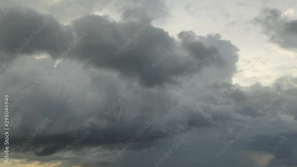 The black rain clouds were moving slowly at sunset time. The black rain clouds were moving slowly at sunset time.