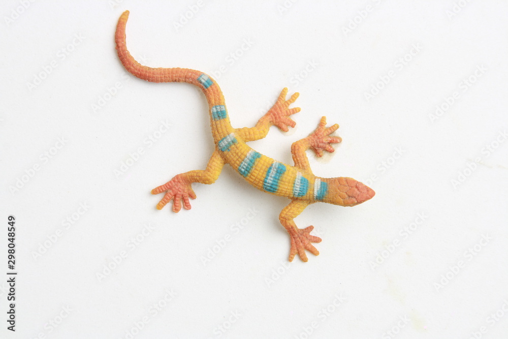 Naklejka premium lizard shaped rubber toy in color background