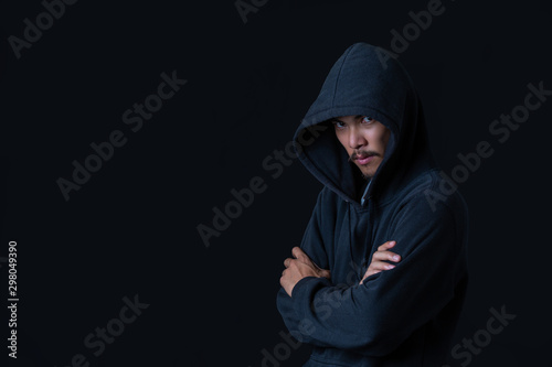 The concept of cyber theft. The hacker standing on her arms against the black background.