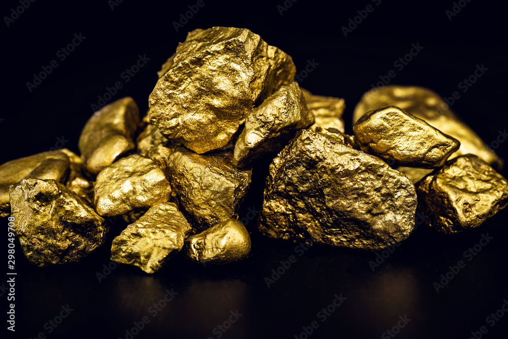 Golden nuggets isolated on black background. Luxury concept. Golden nuggets isolated on black background. Luxury concept.