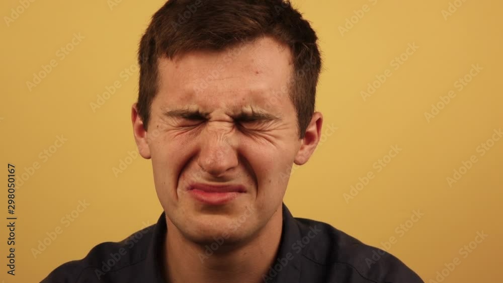 frustrated, the man cries on a yellow background