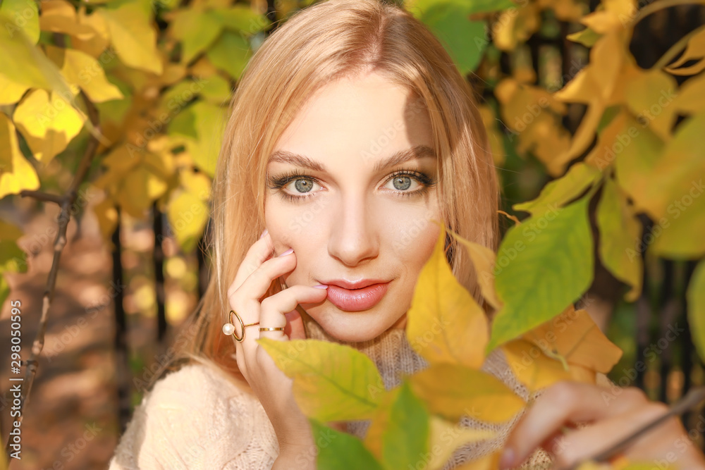 Beautiful young woman near autumn tree in park Beautiful young woman near autumn tree in park