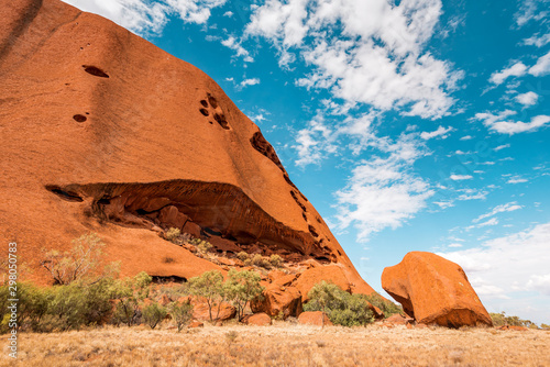 Obraz na płótnie Woman walks on red sand dune in Australia, fiery red sand eroded from huge rock formation and a sanctuary for the Aboriginals w salonie