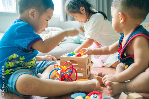 Group of baby playing in cozy room with toy © themorningglory