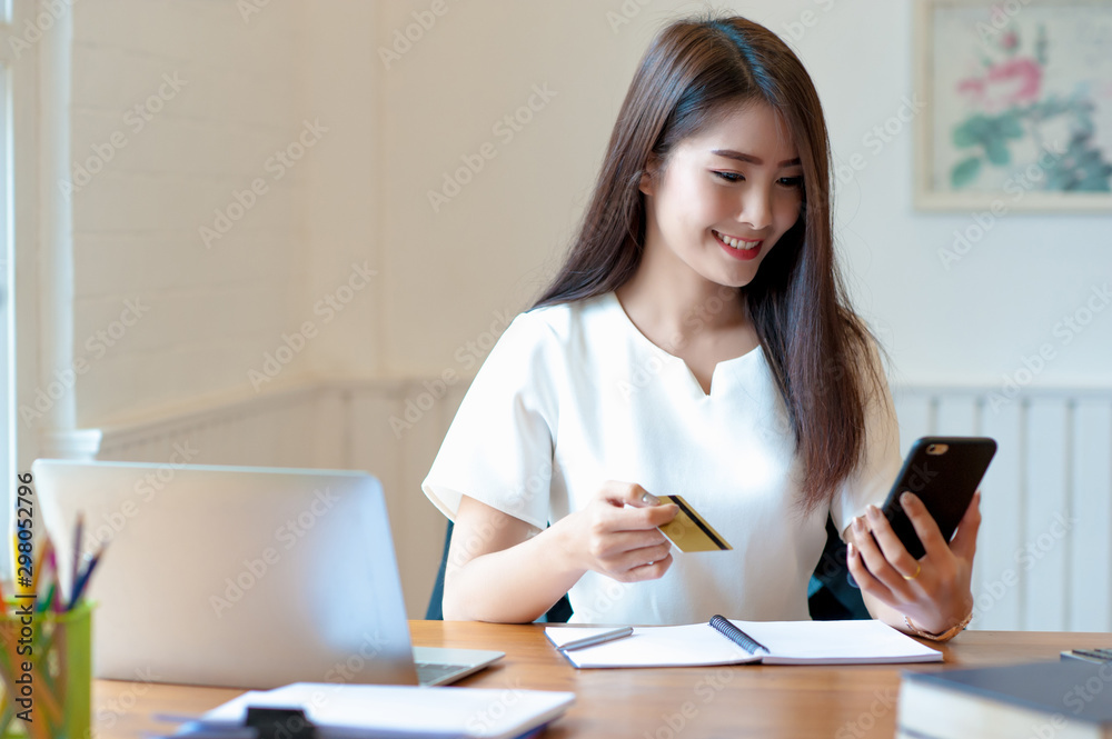 Women are shopping online with mobile phones using credit cards. Women are shopping online with mobile phones using credit cards.