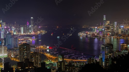 Wallpaper Mural Timelapse various Hong Kong motorboats sail on wide harbor reflecting city highrise buildings and towers silhouettes at night zoom out Torontodigital.ca