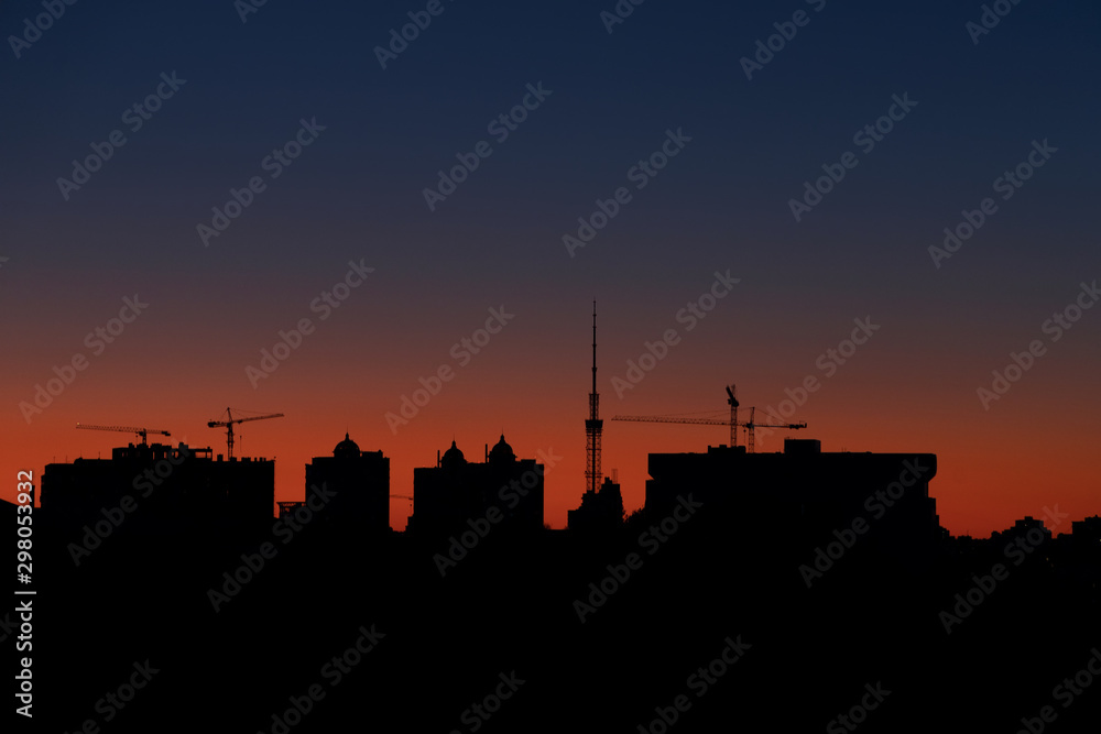 Silhouettes of urban knowledge against the backdrop of sunset or dawn. Horizontal image.