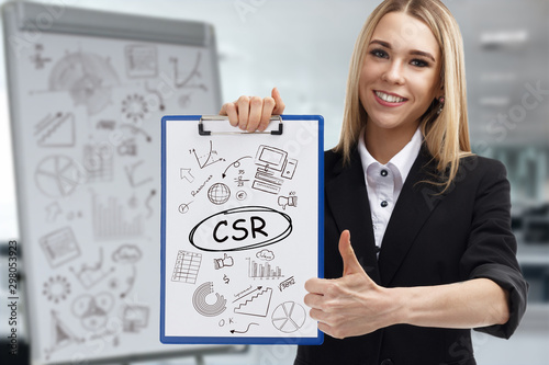 Business, technology, internet and network concept. Young businessman shows a key phrase: CSR