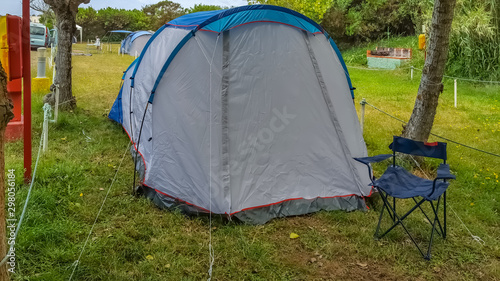 View with camping tent mounted on the grassy ground in campsite