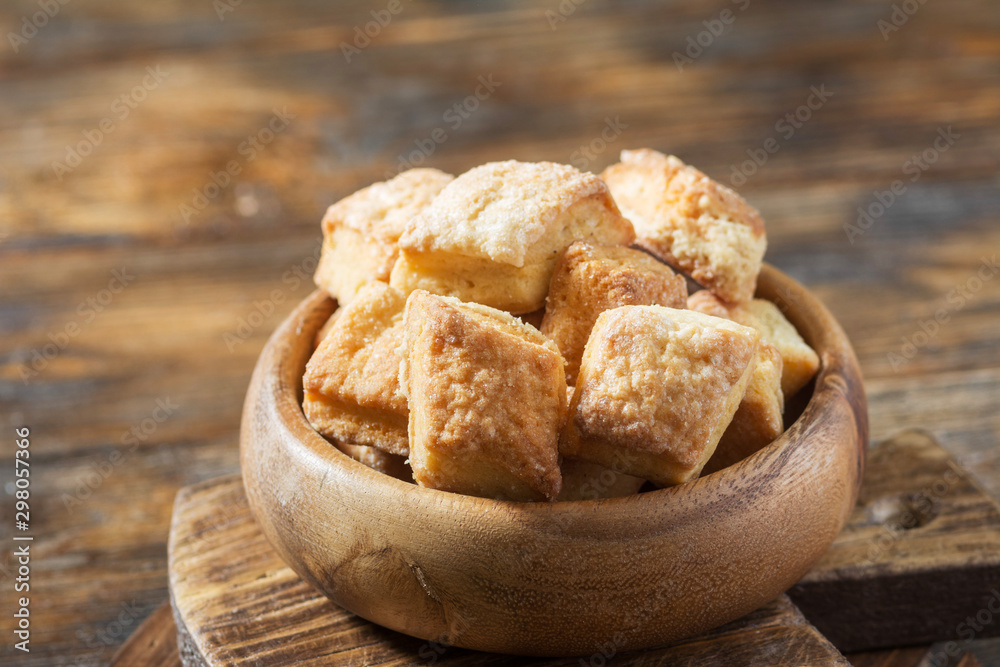 Cottage cheese cookies in a wooden bowl on a wooden table. Rustic style