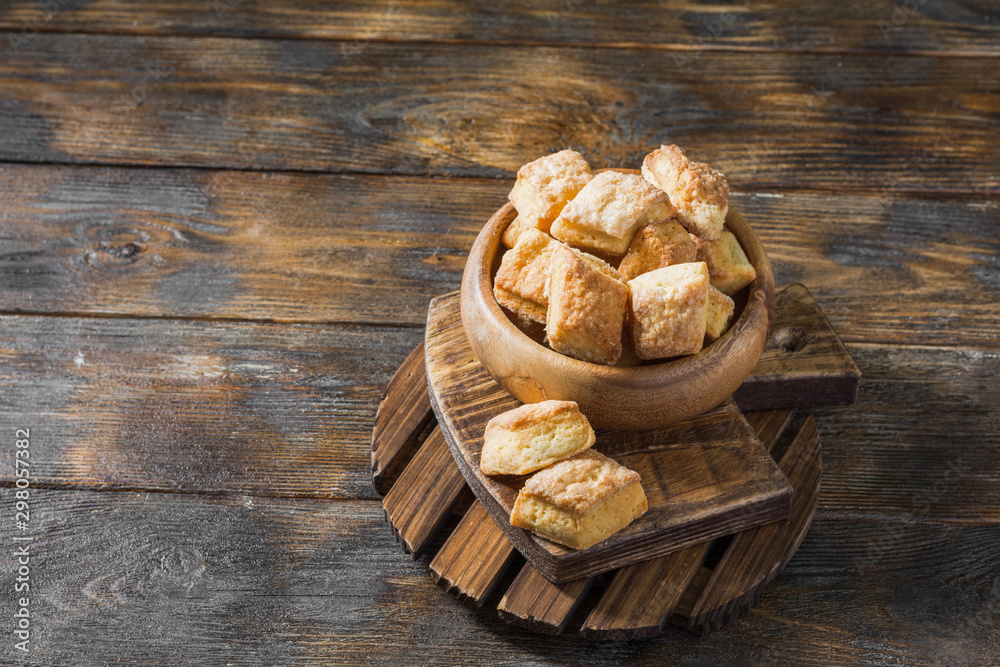 Fototapeta premium Cottage cheese cookies in a wooden bowl on a wooden table. Rustic style