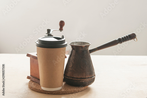 Hot turkish coffee pot on wooden table.