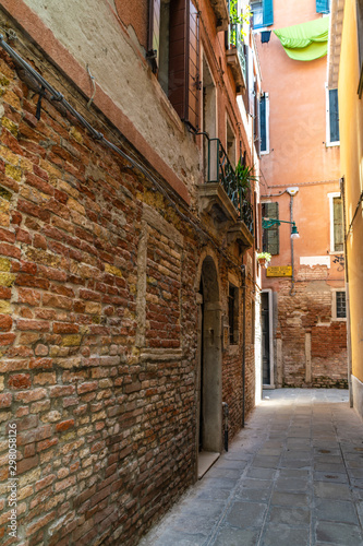 Old narrow venetian street in summer