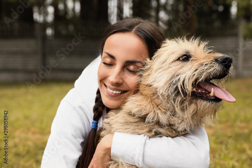 Photography Female volunteer with homeless dog at animal shelter outdoors