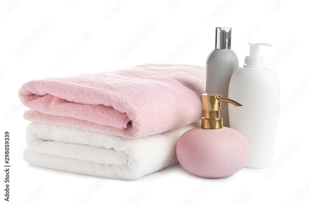 Folded soft towels and toiletries on white background Folded soft towels and toiletries on white background