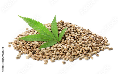 Pile of hemp seeds and leaf on white background © New Africa