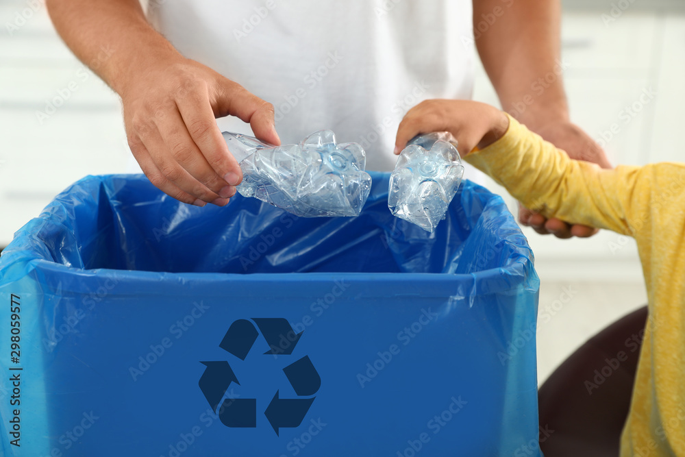 Father and son sorting garbage in kitchen, closeup. Recycling concept - obrazy, fototapety, plakaty 