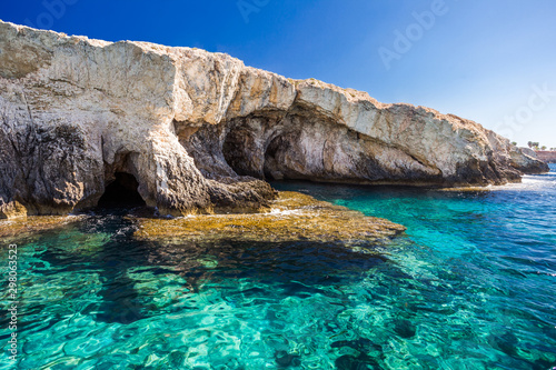Rocky shore, clear turquoise water and blue sky on Cyprus.