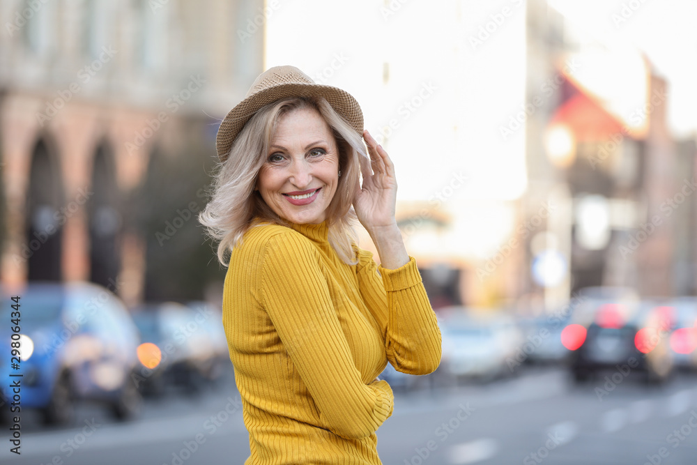 Portrait of happy mature woman on city street