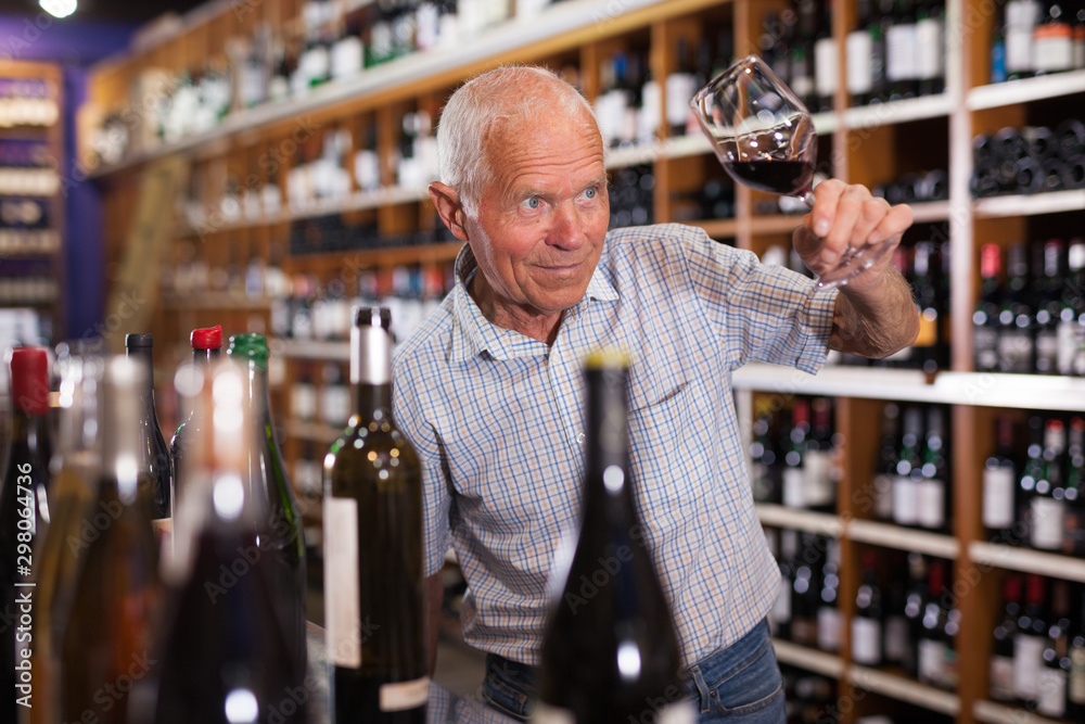 Man tasting wine in wine store