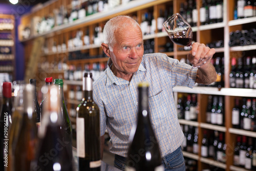 Man tasting wine in wine store